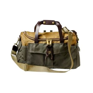 A classic duffel bag in olive green and tan canvas, with leather fixtures, handles and shoulder strap.